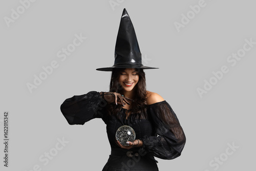 Young witch with crystal ba...