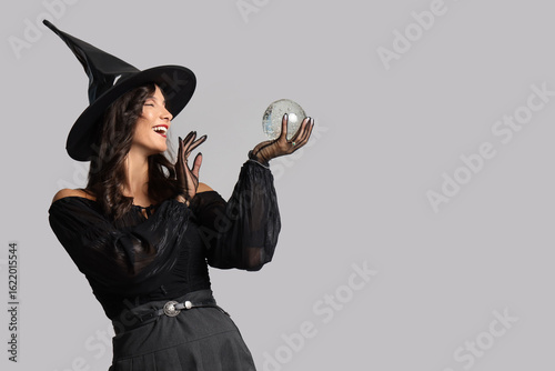 Young witch with crystal ba...