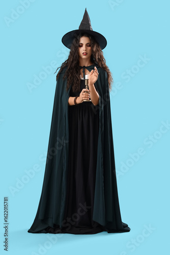 Young witch with burning ca...