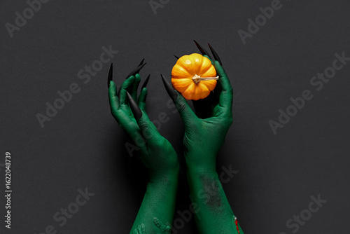 Green hands of witch with p...
