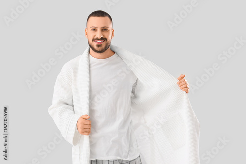 Young man in robe on white ...