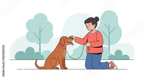 A person on their knees is training a happy dog outdoors in a park setting with trees and bushes in the background