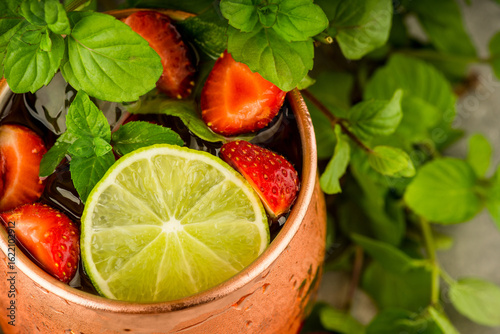 Photography Refreshing Moscow mule cocktail with strawberries on the rustic background
