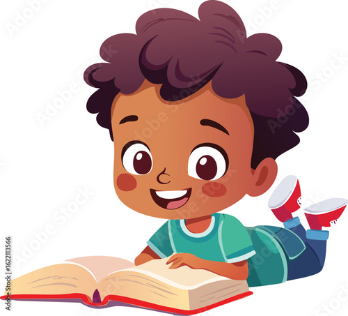 A happy young Black boy with curly hair lies on the floor reading an open book.
