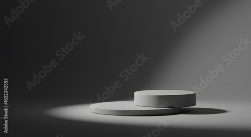 Minimalist gray product display featuring two round podiums under soft light for product showcases and presentation backgrounds.