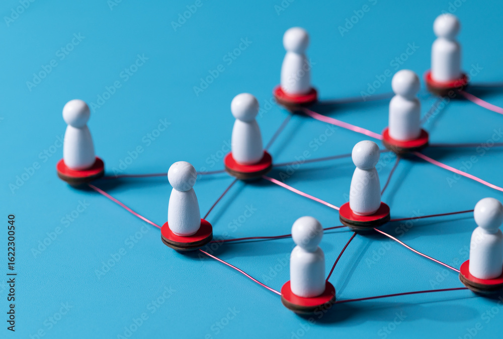 Obraz premium Wooden human figures connected by glowing thread — HR network and team connectivity on blue Background