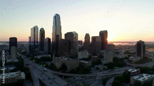 Drone View of City Traffic Between Tall Buildings Golden Hour Light 4K Cinematic

