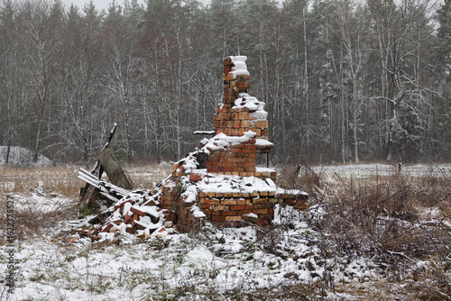 A destroyed house with only a stove left. War in Ukraine. The remains of a blown-up house against a winter landscape.