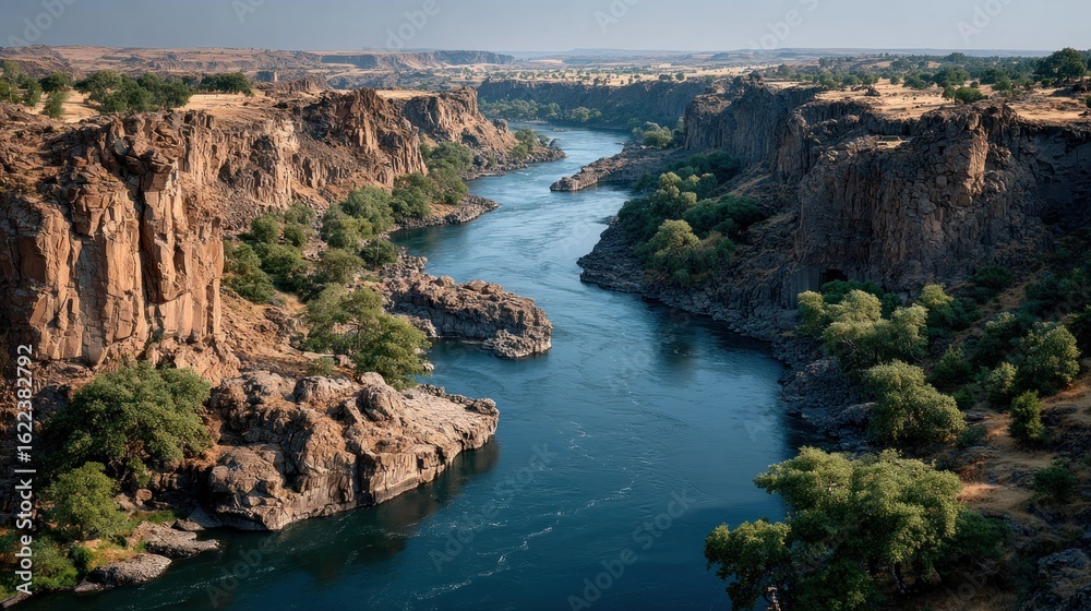 Obraz premium River winding through dramatic canyon landscape