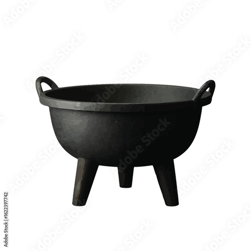 Traditional black cast iron cauldron on three legs with handles