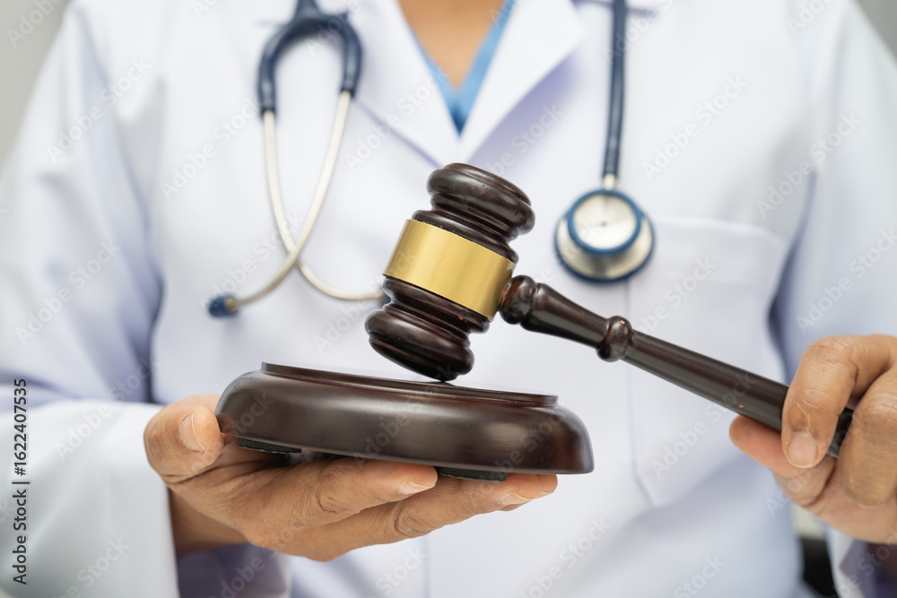 Obraz premium Doctor holding judge gavel, forensic medicine, medical law and crime justice.