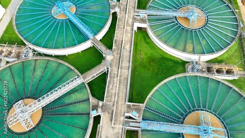Drone shot of a modern wastewater treatment plant featuring sedimentation tanks and filtration systems, emphasizing infrastructure designed to treat and recycle water efficiently and safely.
