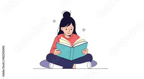 Young woman sitting cross legged enjoying reading a large book with open pages and a gentle smile on her face