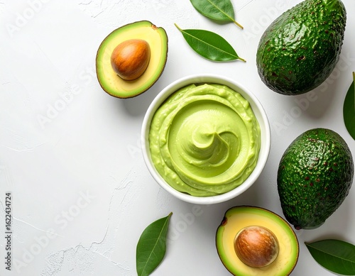 Overhead shot of avocado mousse in white bowl, wide composition with space for text. Fresh, creamy, and healthy, perfect for dessert, vegan, and food photography projects.