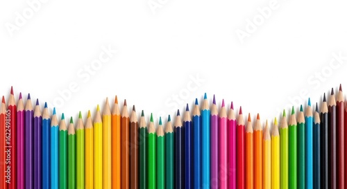 Vibrant colorful pencils aligned in creative wave on white background