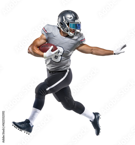 American football player running in grey uniform holding football and looking behind