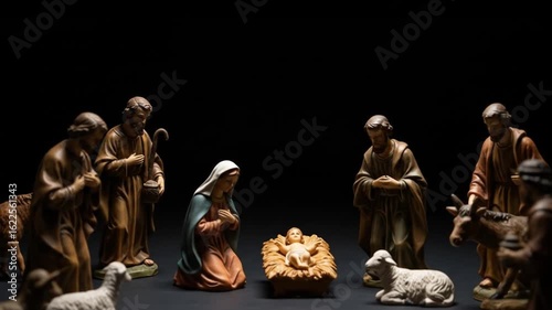 Nativity Scene with Wooden Figurines Depicting Birth of Jesus in Minimalist Dark Setting