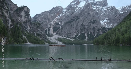 Breathtaking mountain lake with crystal clear water and lush greenery in the early morning light