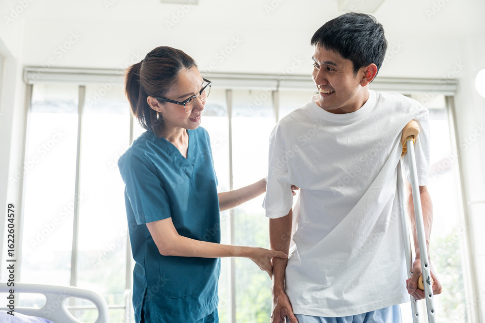 Fototapeta premium Physical therapy. Female Nurse aids young man in recovering from spine injury and providing orthopedic massage Orthopedic healthcare and chiropractor with person for physical therapy rehabilitation