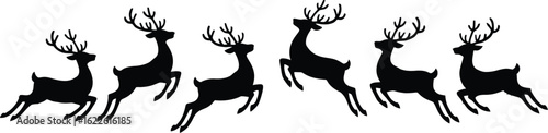 Silhouette of a herd of reindeer running together with antlers