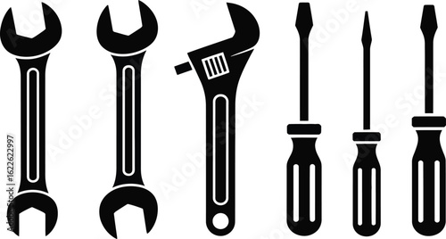 Collection of silhouetted wrenches and screwdrivers on white background