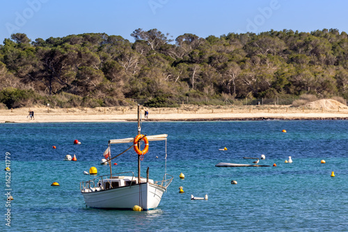 Small traditional llaut boat and buoys in the harbor bay of Colonia de Sant Jordi, Majorca, Mallorca, Balearic Islands, Spain, Europe