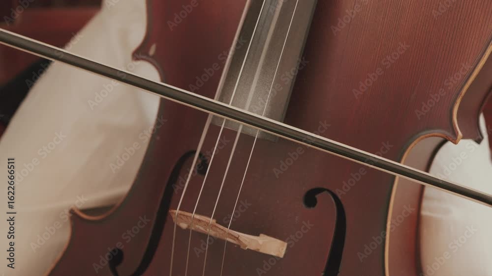 close up of cello being played with bow showing fine wood texture and elegant sound holes close up of cello being played with bow showing fine wood texture and elegant sound holes