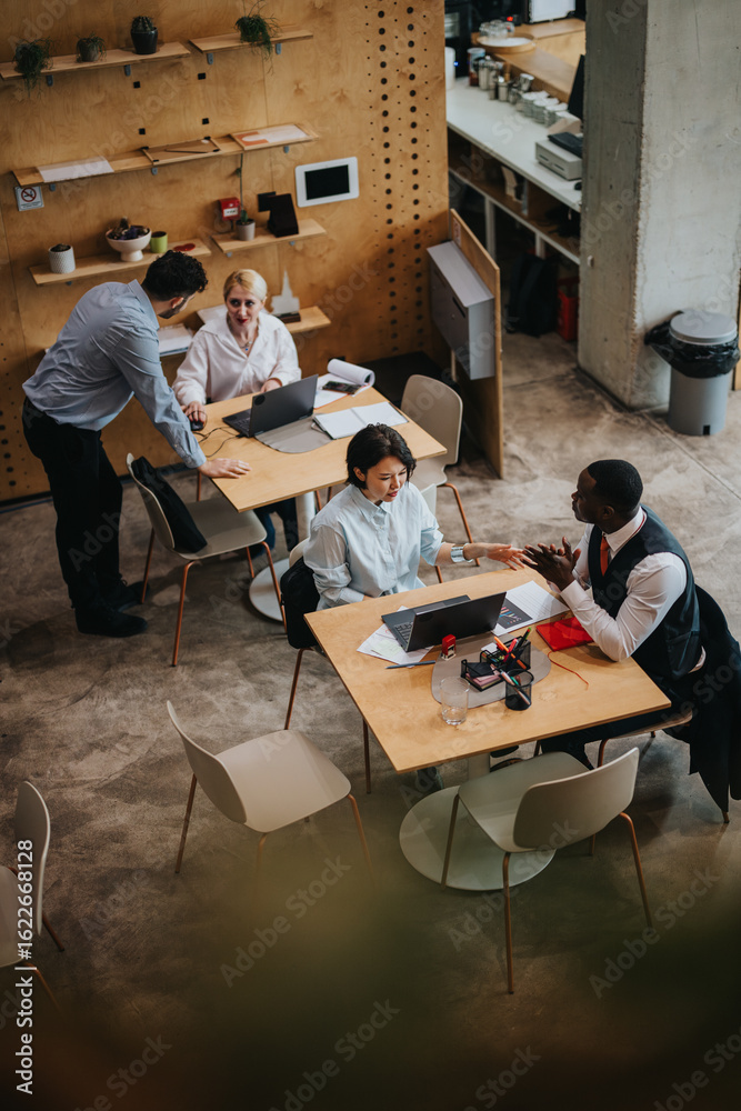 © qunica.com - Group of people collaborating in a rustic co working space with a comfortable, modern design. The setting fosters creativity, teamwork, and productive discussions among team members. © qunica.com - Group of people collaborating in a rustic co working space with a comfortable, modern design. The setting fosters creativity, teamwork, and productive discussions among team members.
