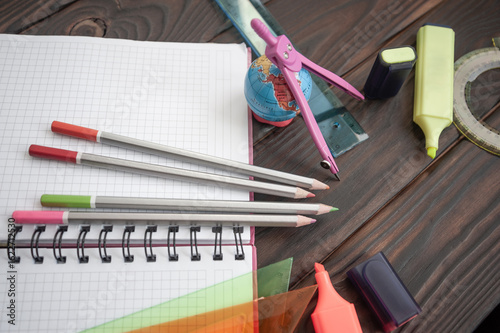 office or school stationery on wooden surface