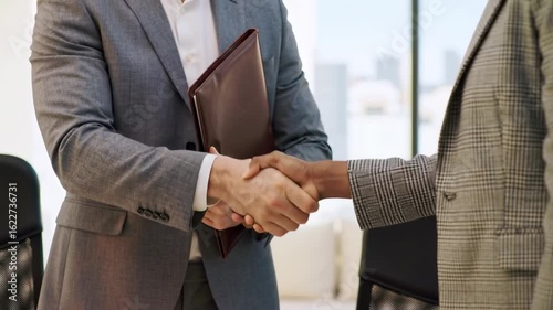 Business handshake in modern office