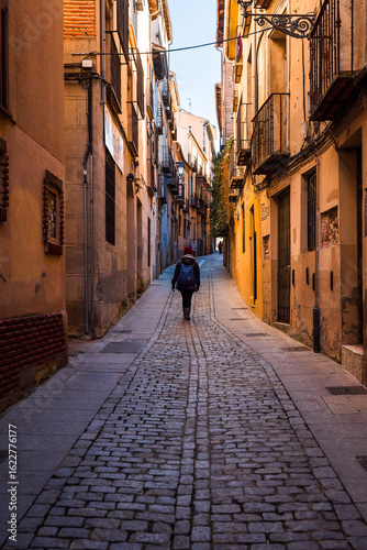 Segovia, Spain: Person walking through the narrow streets of the old town in Segovia