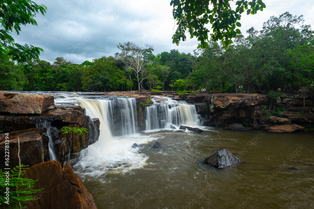 Fototapeta premium Beautiful waterfall, violent stream in the deep forest.Tropical waterfall Tadtone in climate forest, Chaiyaphum Province in Northeast thailand.