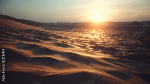 Golden sand dune landscape with warm sunlight at sunset