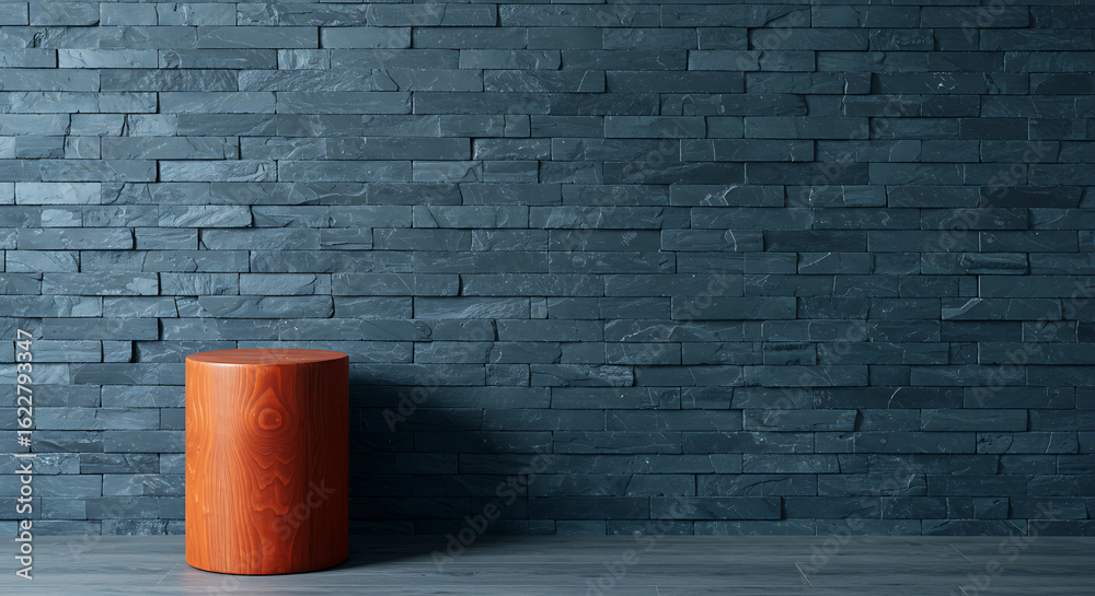 Obraz premium Dark Grey Stacked Slate Wall with Cylindrical Wooden Stool in an Empty Studio Setting
