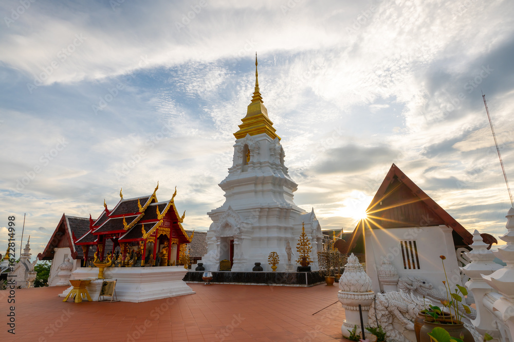 Naklejka premium Phra Chaiyaphum Siri Maha Chedi (Arun Dhamma Sathan), which is located in Chaiyaphum, Thailand, is famous place in view under blue sky and sunset clouds. 