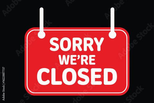 Bright red sign declares sorry we re closed with white text and hanging cords