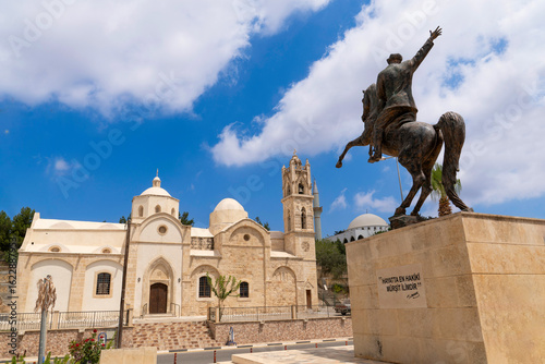 Dipkarpaz, Karpas Peninsula, Northern Cyprus - July 14, 2025: Statue of Ataturk on a horse and  old orthodox Ayios Synesios Church in the background