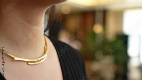 Golden necklace on woman neck
