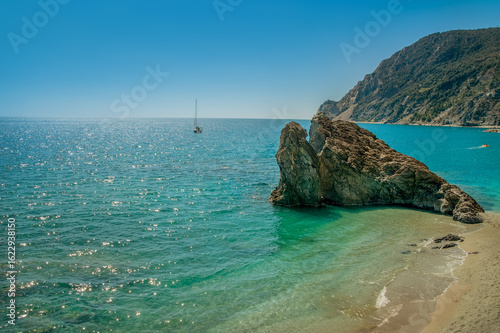 Top view of the sea stones on shore, turquoise Mediterranean Sea, Monterosso