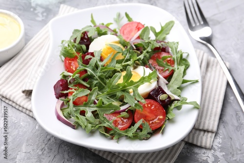 Wallpaper Mural Tasty salad with arugula, vegetables, egg and seeds on grey table, closeup Torontodigital.ca