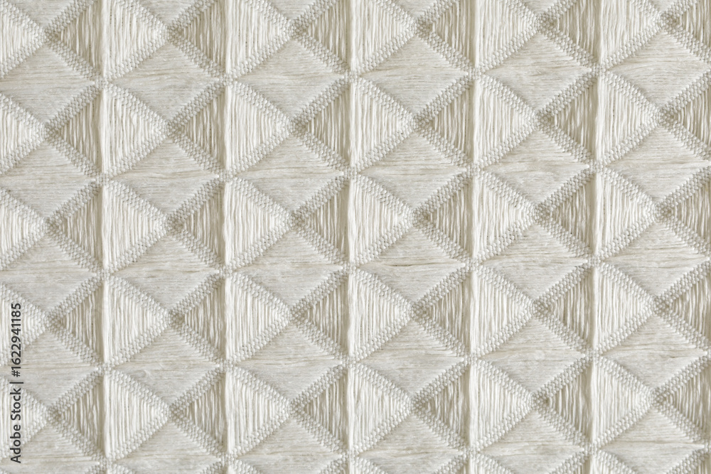Obraz premium High-resolution image of beige fabric with a textured diamond pattern. Perfect for textile, background, and design proje