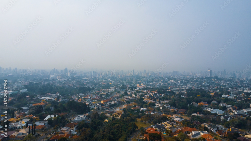 Naklejka premium Aerial drone shots of Bosque Alemão in Curitiba showcasing forest trails and cultural landmarks