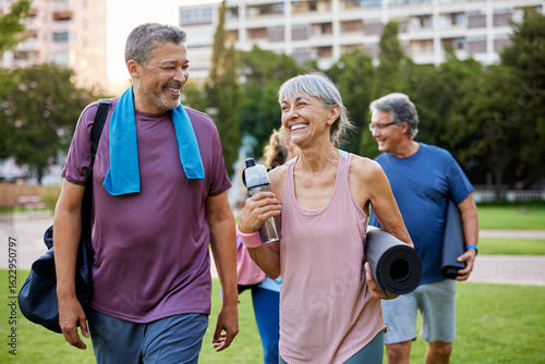 Healthy mature people chatting after workout