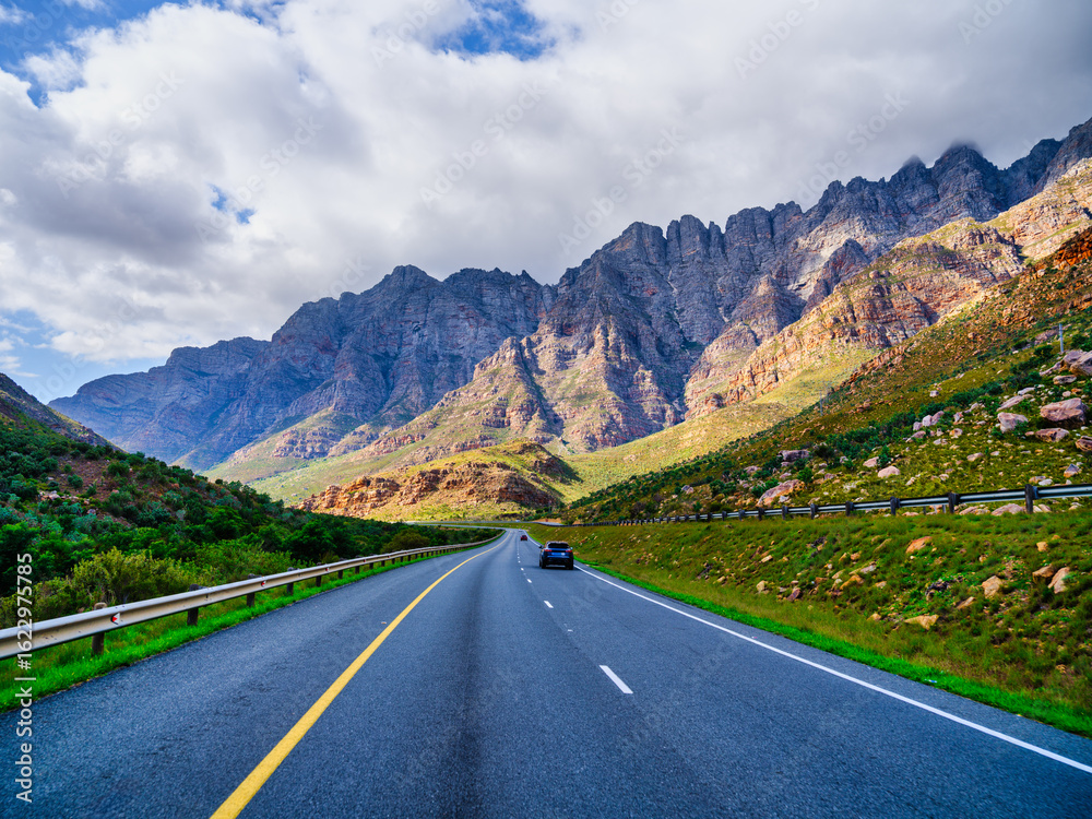 Naklejka premium N1 Highway in shadow with sunlit Du Toitskloof Mountains, Western Cape, South Africa