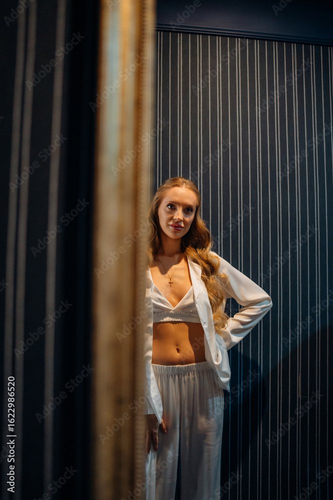 Reflection of beautiful young woman in white silk pajamas. Reflection of beautiful young woman in white silk pajamas.