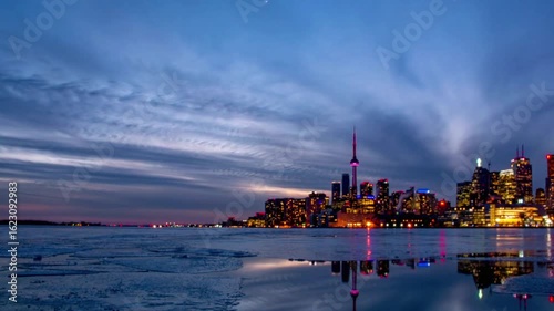 Toronto skyline at sunset with reflection in the water in winter