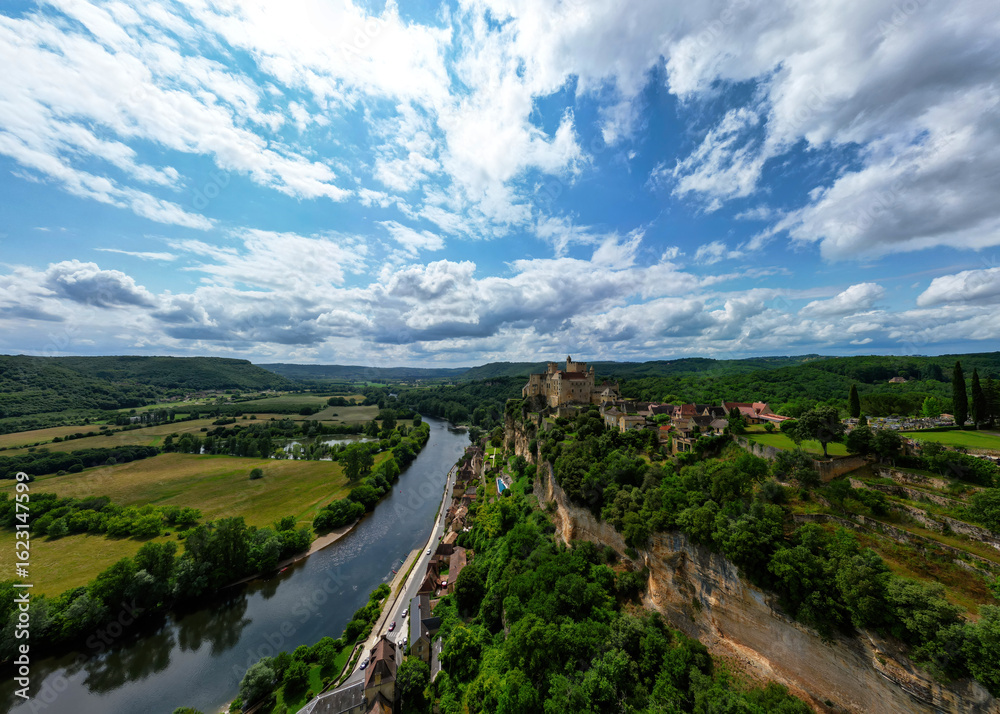 Obraz premium The Château de Beynac, a castle in the commune of Beynac-et-Cazenac, perched on top of a limestone cliff, dominating the town and the north bank of the Dordogne