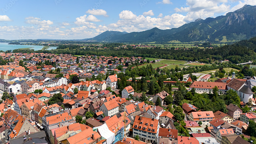 Fototapeta premium Fussen aerial panorama with alpine mountains, river, and historic town in Germany