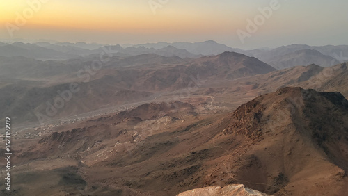 Sunset Over Desert Mountains with Orange and Purple Sky
