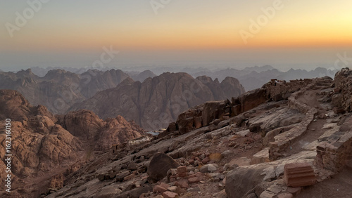 Sunset Trail Along Rocky Mountain Ridge with Distant Peaks